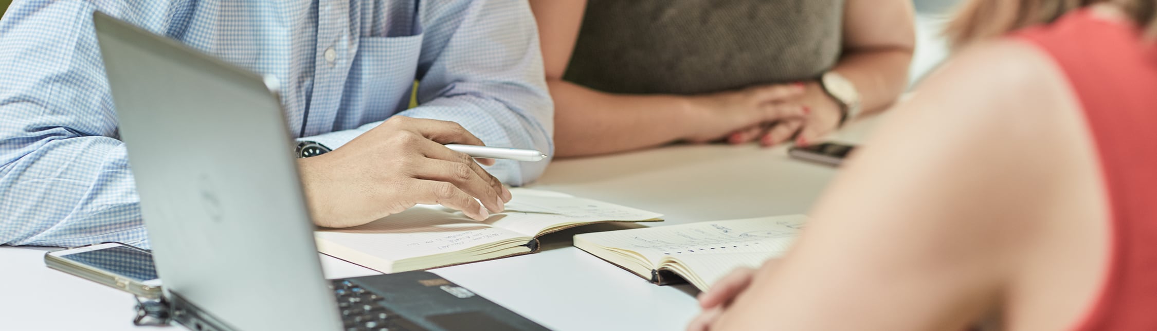 Close-up of colleagues in a meeting banner