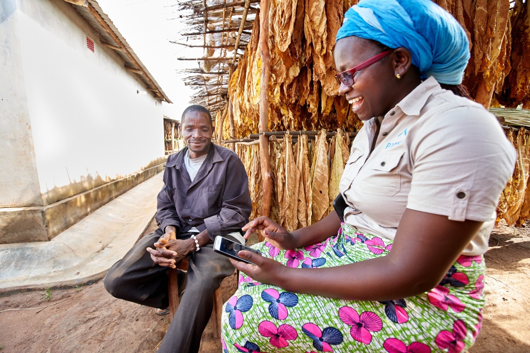 A farmer and a field technician discuss a worker agreement in Malawi