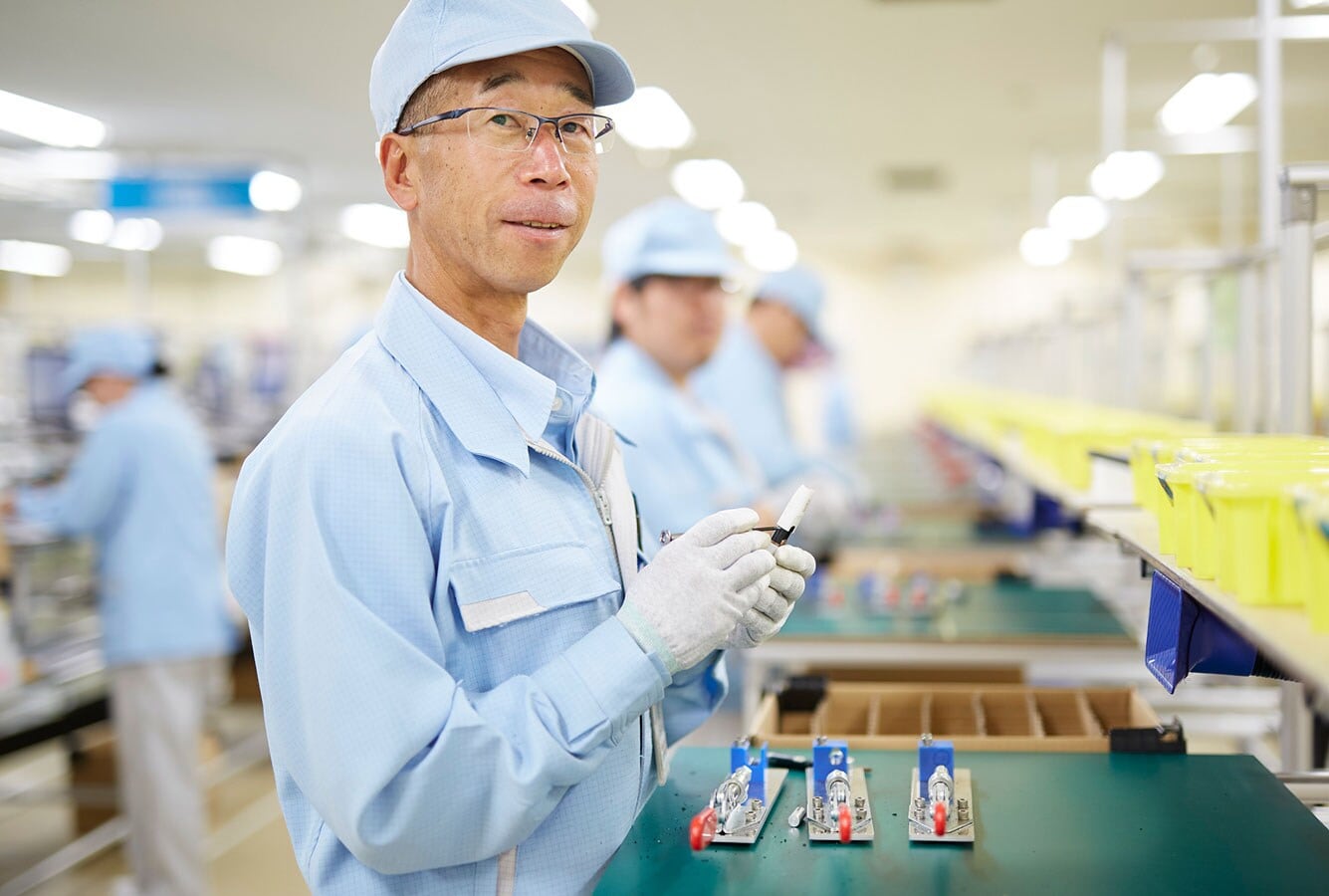 Worker recycling heated tobacco products in Japan
