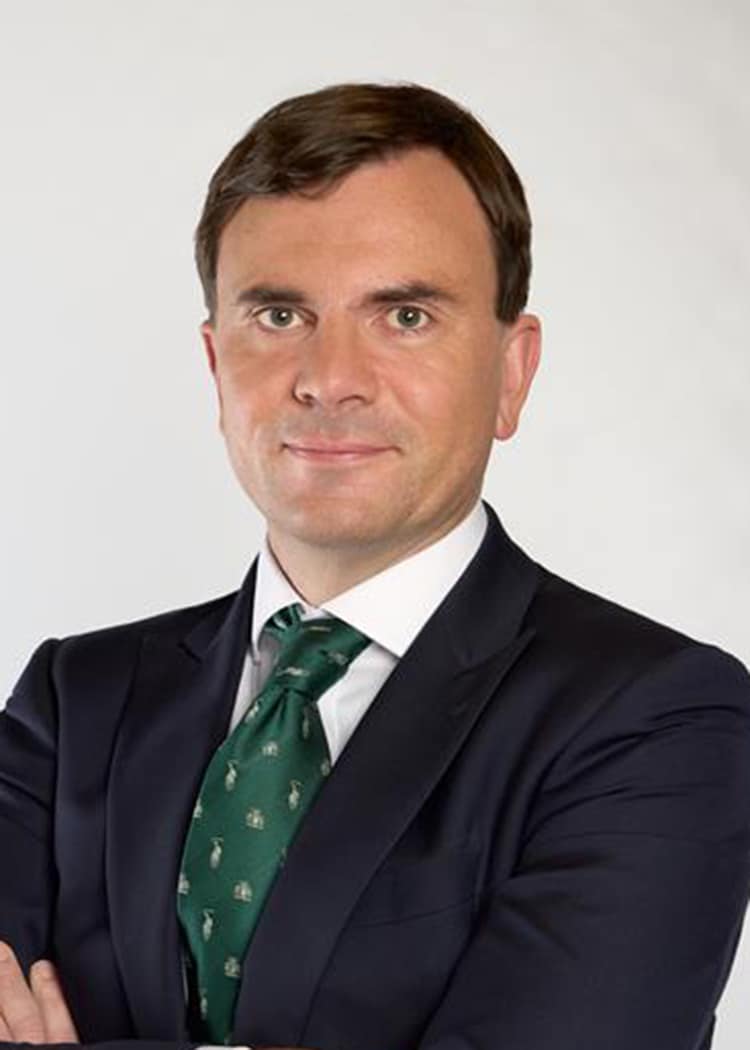 man in dark jacket and green tie