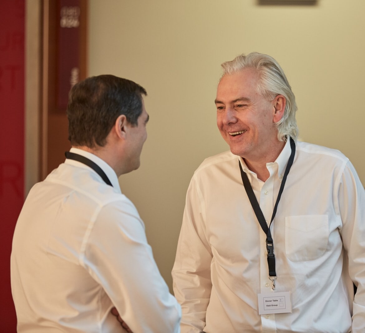 Two people engaged in conversation at a corporate event