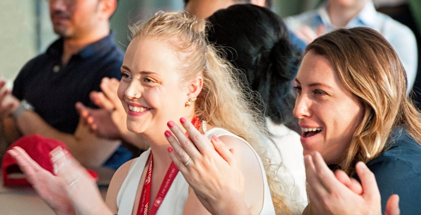 Colleagues applauding during a workplace event.