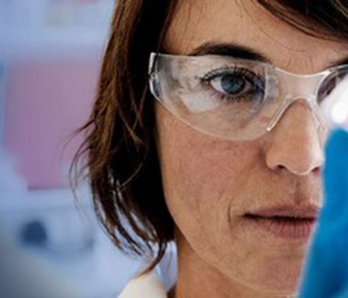 Female scientist wearing protective glasses