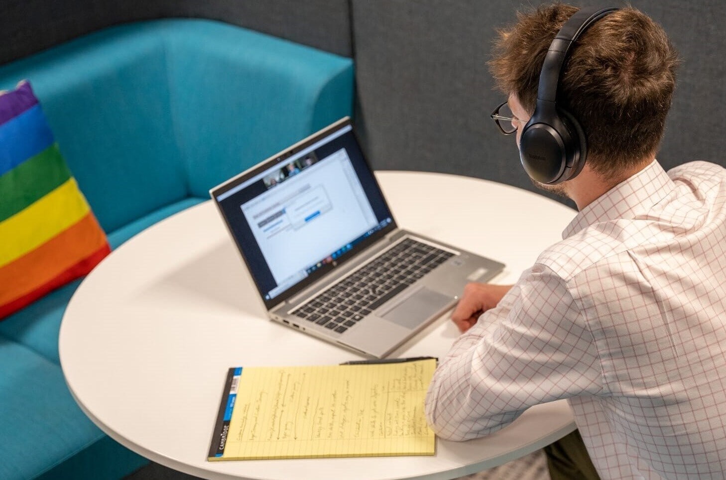 man in front of a laptop with headset man in front of a laptop with headset