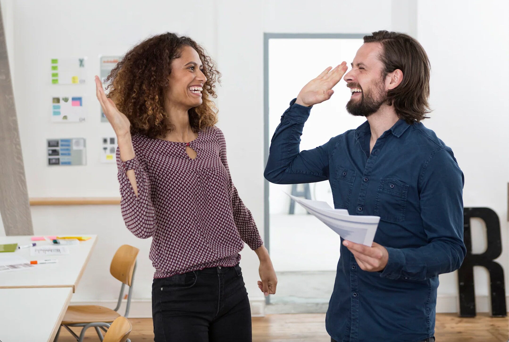 two people giving high five two people giving high five