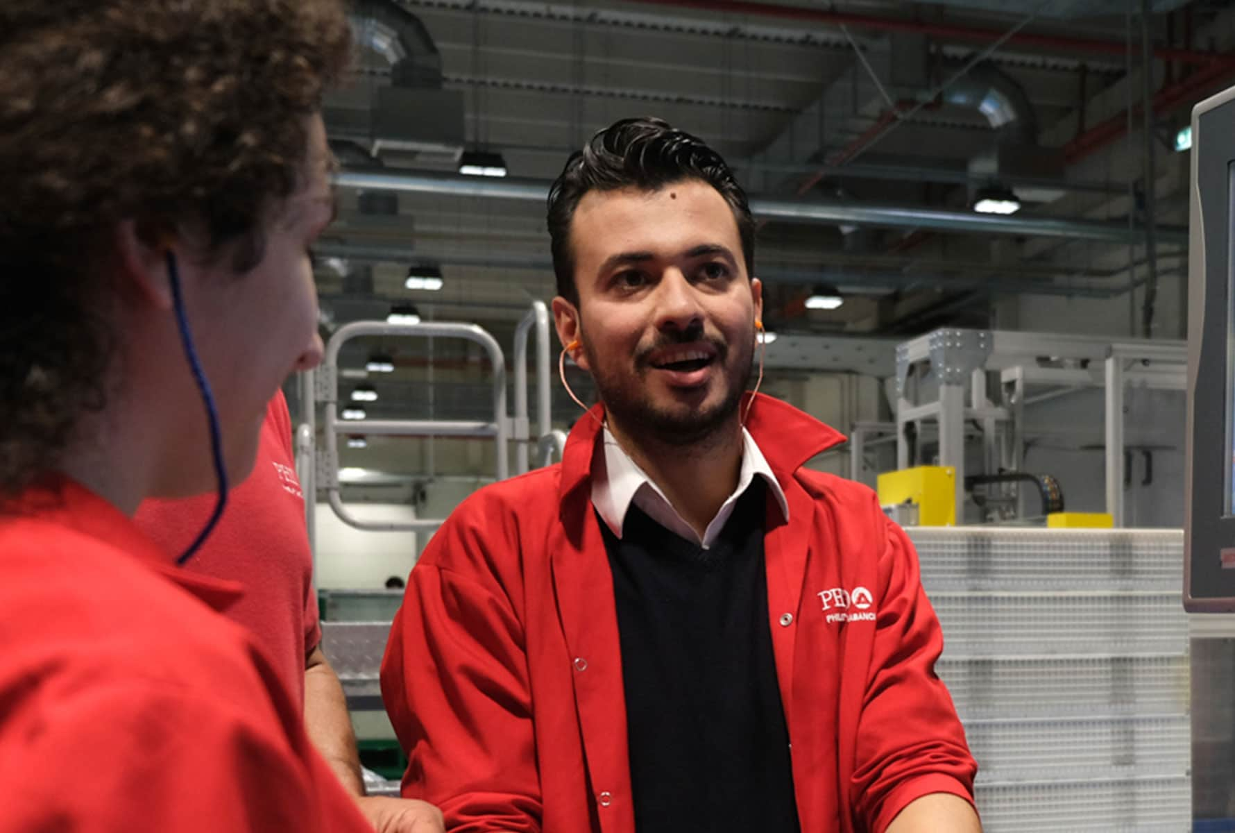 Two employees in a PMI manufacturing facility.