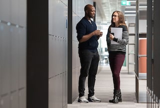 Male and female colleagues in open-plan office