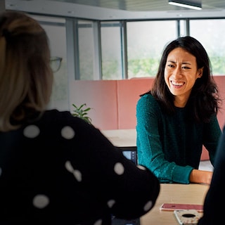 Female colleagues laughing in office