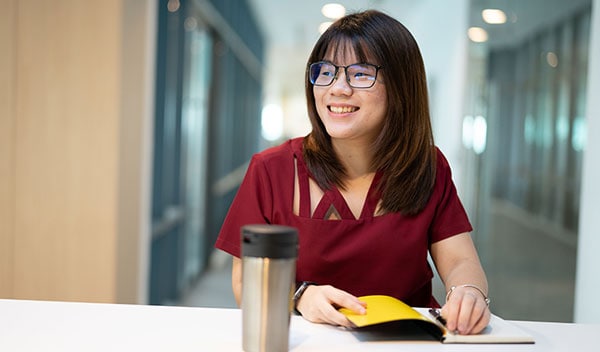 Smiling women writing in notepad