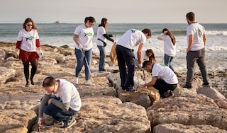 PMI employees cleaning up a beach in Portugal.