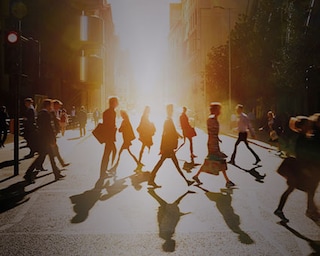 People crossing the street in a city