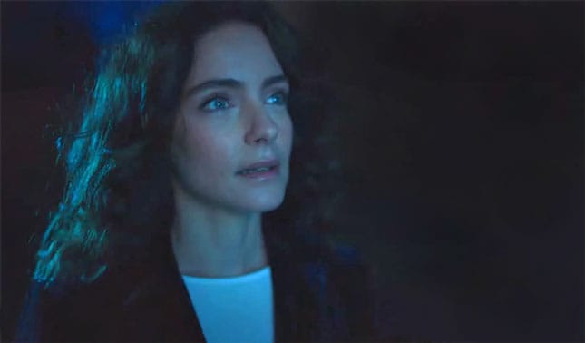 woman watching a video in a darkened room