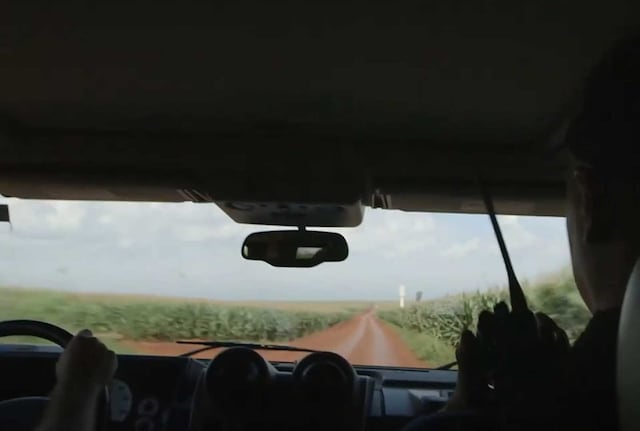 Two men driving through fields
