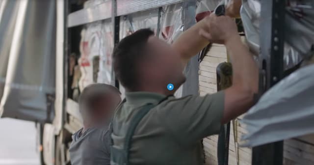 Customs officer searching a truck