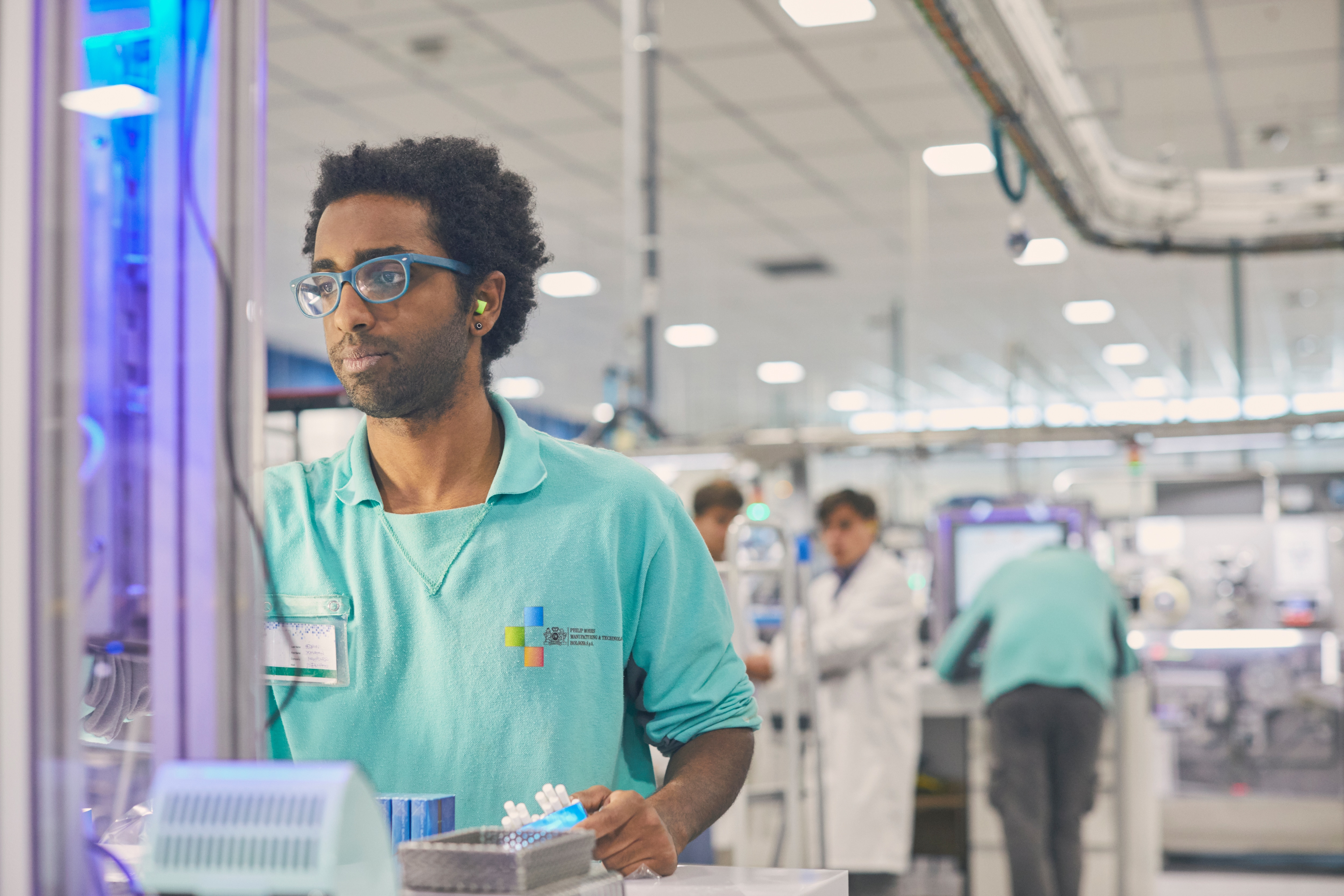 Employees at work in PMI’s heated tobacco manufacturing facility in Bologna, Italy.