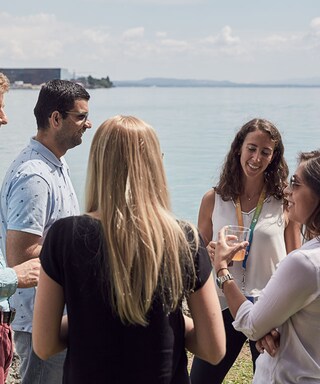 Groups of friends talking by a lake