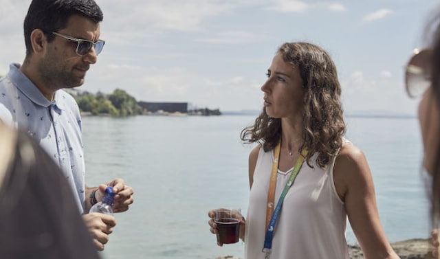 Man and woman talking by a lake