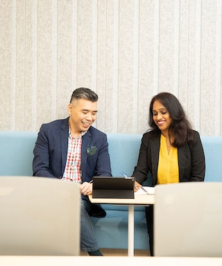 Male and female colleague talking in office