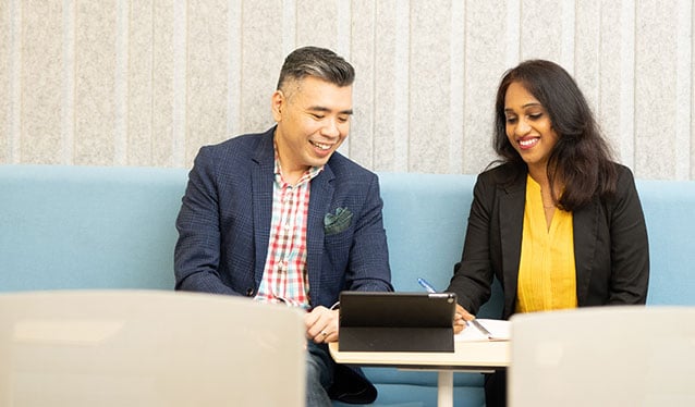 Male and female colleague talking in office