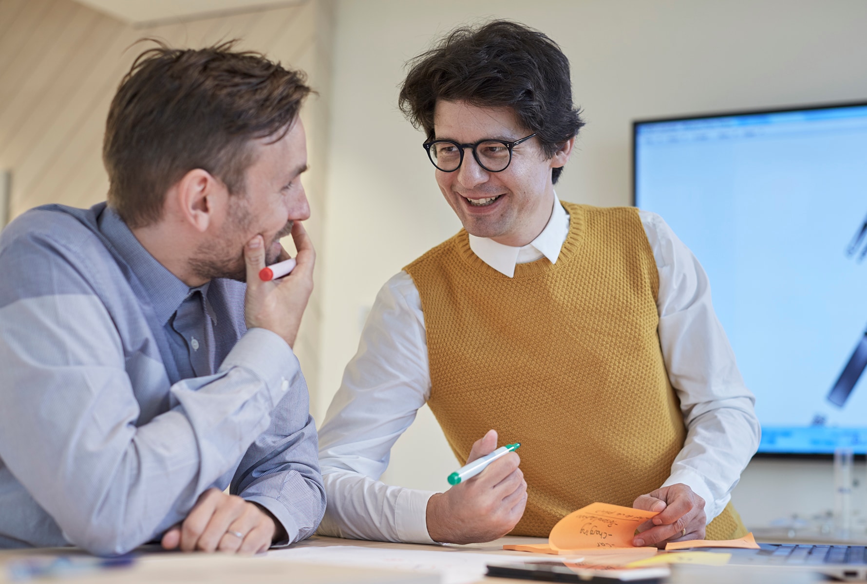 Two PMI employees discussing and smiling