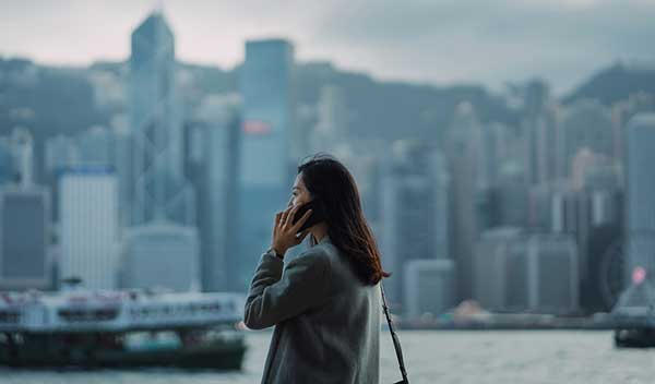 Woman talking on the phone against a city skyline