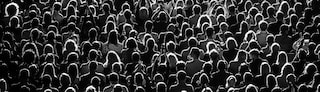 An arial view of a crowd of people, showing the backs of their heads.