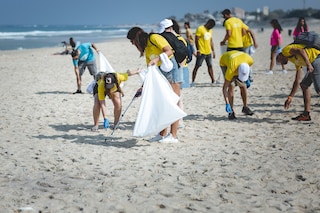 Collecting cigarette butts on the beach