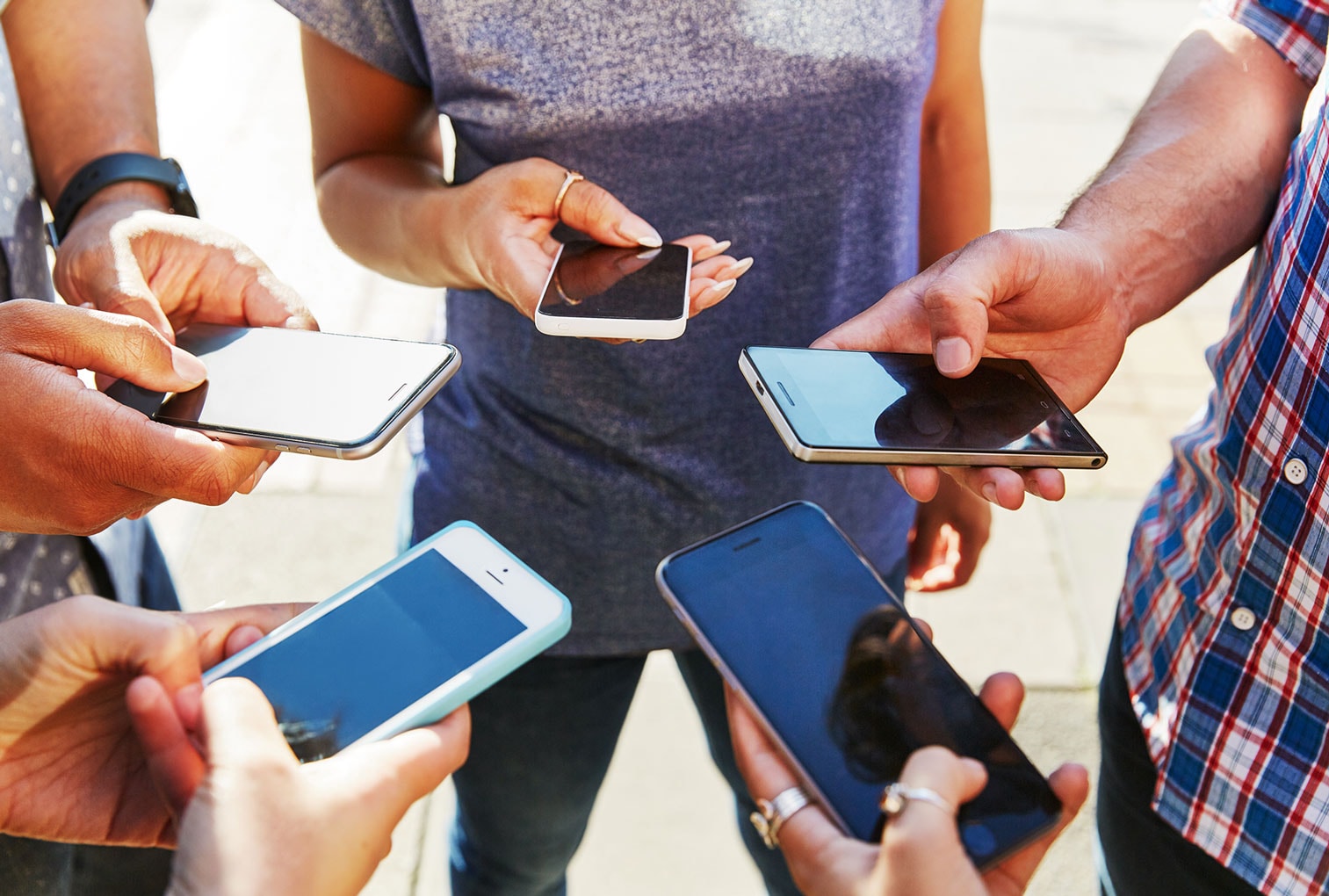 Group of people holding mobile phones