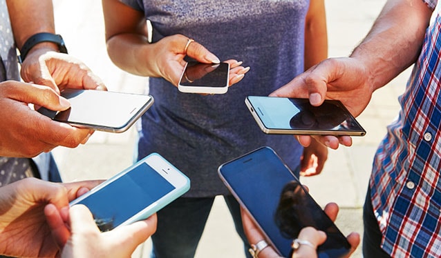 Group of people holding mobile phones