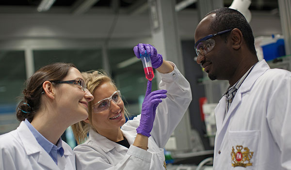 Diverse group of PMI scientists in the laboratory