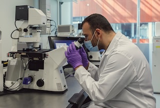 Scientist looking through a microscope