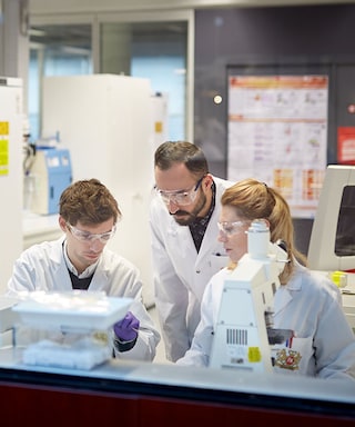 Three scientists in a PMI laboratory in Neuchatel, Switzerland