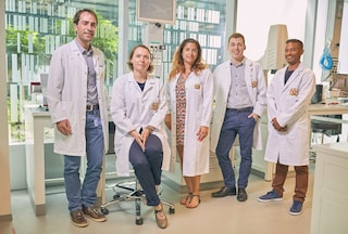Group od scientists posing for a photo in PMI center cube, neuchatel.