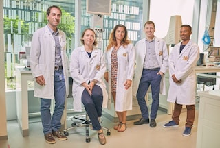 Group of scientists posing for a photo in PMI center cube, neuchatel.