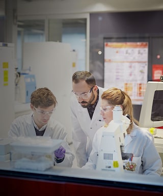 Three scientists in a PMI laboratory in Neuchatel, Switzerland