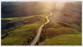 Road winding through a green countryside