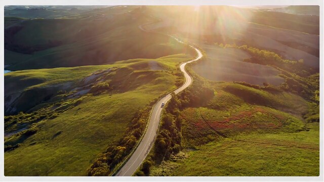 Road winding through a green countryside