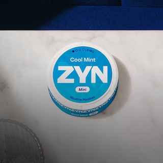 A tin of Zyn nicotine pouches on table by Philip Morris International