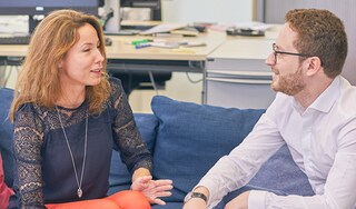 Work colleagues talking on a sofa