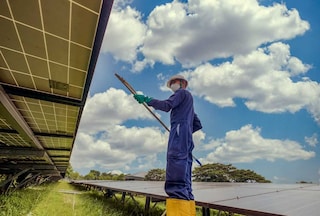 Operative attending to solar panels on a cloudy day