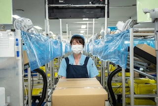Female worker wearing a mask in a recycling plant