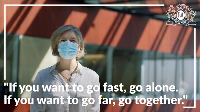 woman with mask in white shirt with white writing