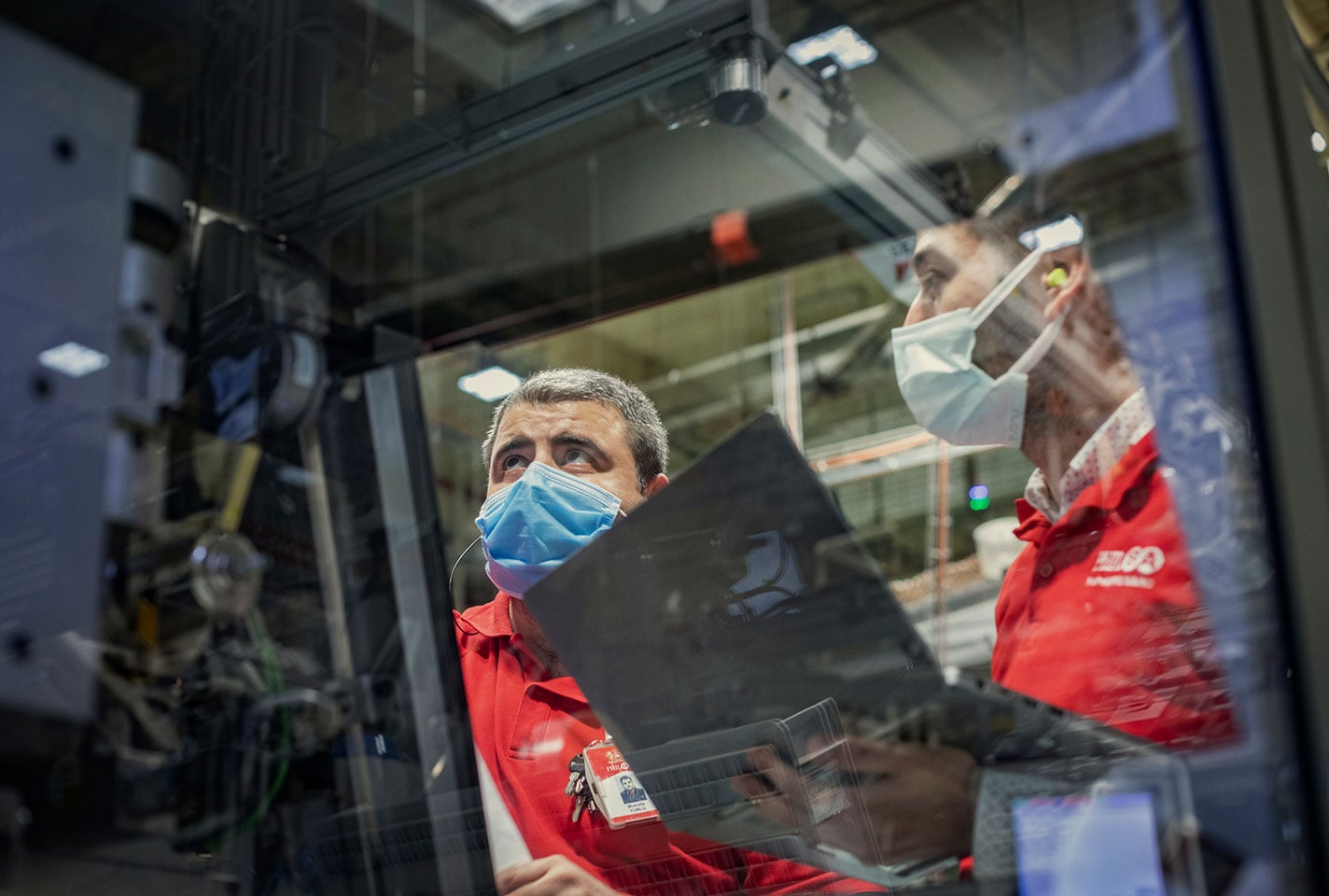 Two factory workers in masks