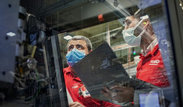 Two factory workers in masks