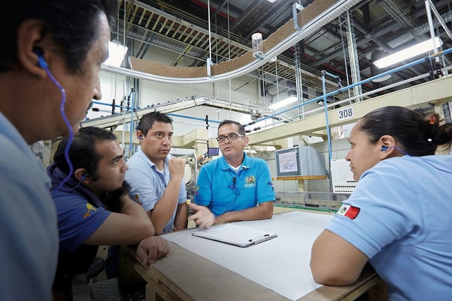 PMI employees talking inside the factory.