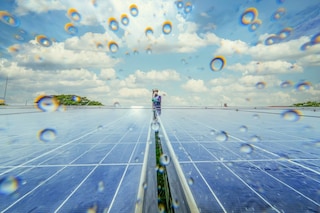Two solar panels pictured in light rain