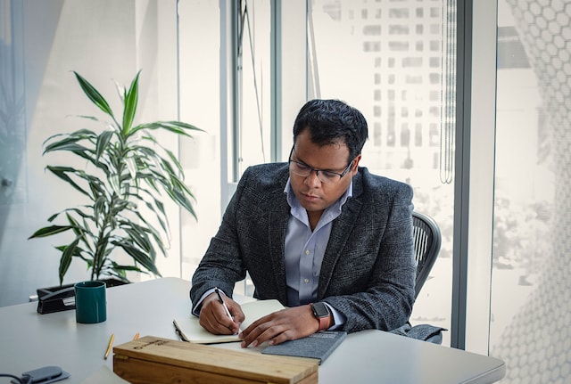 Male executive writing in an office