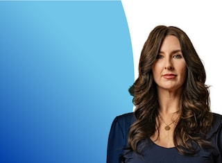 Brunette woman facing camera against blue background