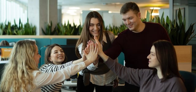 Employees at Philip Morris Ukraine doing high fives