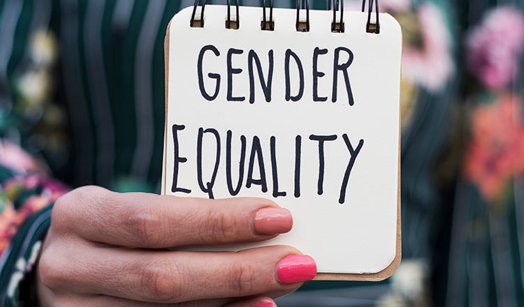 Woman holding a sign for gender equality